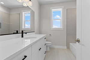 Full bath featuring vanity and bathing tub / shower combination