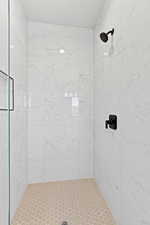 Full bathroom featuring tiled shower