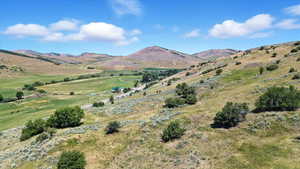 View of mountain backdrop with rural landscape