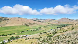 View of mountain background featuring rural landscape