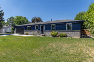 Ranch-style house with brick siding, a garage, concrete driveway, and roof with shingles