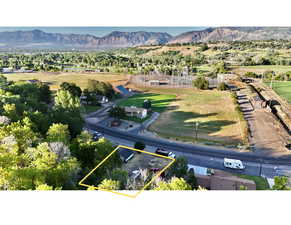 Aerial view of property and surrounding area featuring a mountain backdrop and property boundaries highlighted