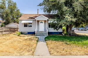 Bungalow-style house featuring roof with shingles