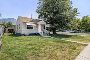 Bungalow-style house featuring a front yard and roof with shingles