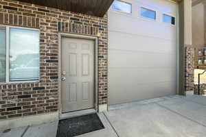 Entrance to property featuring brick siding