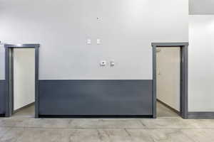 Unfurnished room with elevator and concrete flooring