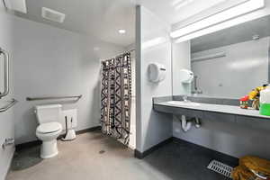 Bathroom featuring tile patterned floors and curtained shower