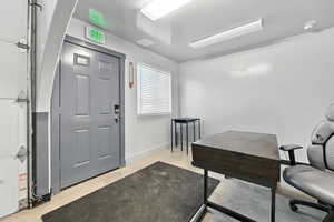Home office with concrete flooring and baseboards