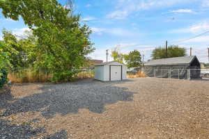 View of yard with a storage shed