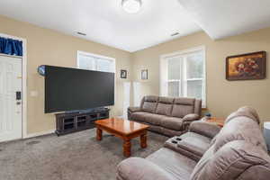 Living room featuring carpet flooring and baseboards