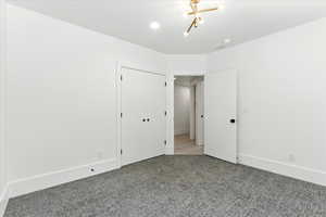 Unfurnished bedroom with baseboards and carpet floors