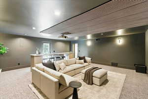 Cinema room with carpet floors and recessed lighting
