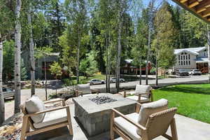 Surrounding community with a lawn and a patio