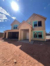 Rear view of property with brick siding