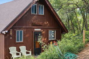 front view of house with a shingled roof brightebed with chat gpt