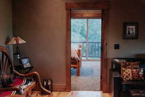 Bedroom with wood finished floors and access to exterior