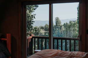 Bedroom with a mountain view and view of scattered trees