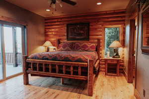 Bedroom with access to exterior, light wood-style flooring, and recessed lighting