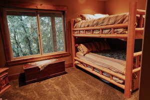 Bedroom featuring carpet and baseboards