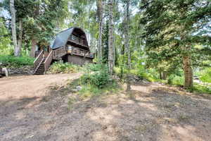 View of yard featuring stairway and a view of trees
