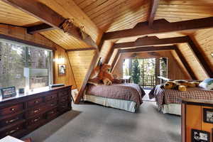 Bedroom with wooden ceiling, carpet, access to outside, and wood walls