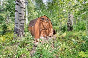 View of shed with a view of trees