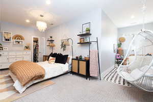 Bedroom featuring baseboards, a spacious closet, recessed lighting, a chandelier, and light colored carpet