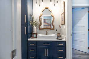 Bathroom with vanity and wood finished floors