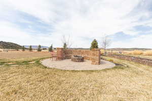 View of yard with a patio area and a fire pit