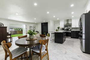 Dining space featuring recessed lighting
