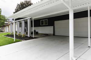 View of side of property with brick siding and an attached garage