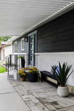 Doorway to property with brick siding