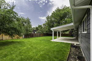 Fenced backyard featuring a patio