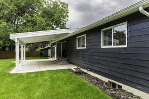 View of yard with entry steps and a patio