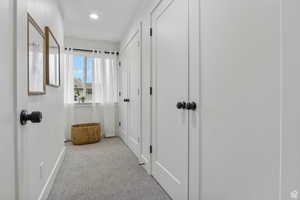 Corridor with carpet floors and recessed lighting
