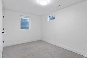 Spare room with carpet floors and a textured ceiling