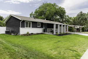 Ranch-style house with an attached carport, brick siding, driveway, and roof with shingles