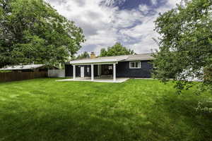 Back of house featuring a patio area and a chimney