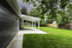 Fenced backyard featuring a patio
