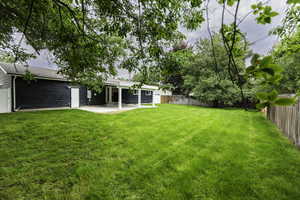 Fenced backyard featuring a patio area