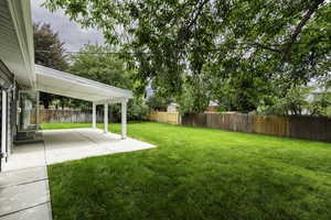 Fenced backyard with a patio area