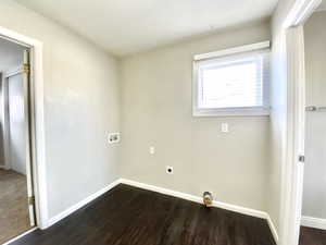 Unfurnished bedroom with baseboards and dark wood finished floors