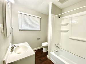 Full bathroom featuring wood finished floors,  shower combination, and vanity