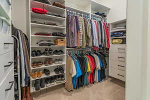 Walk in closet featuring carpet flooring