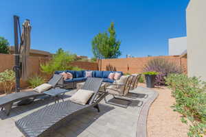 Fenced backyard with an outdoor living space and a patio