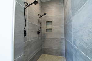 Full bath featuring tiled shower