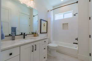 Bathroom featuring shower / bath combo and vanity