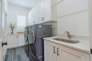 Laundry area with cabinet space and separate washer and dryer