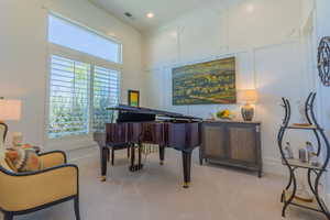 Living area with light carpet and baseboards