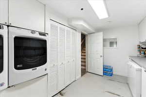 Laundry area featuring cabinet space and washer / dryer